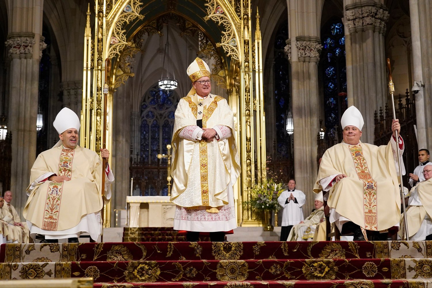 Cardinal Dolan is flanked by his new Auxiliary Bishops Joseph A. Espaillat and John S. Bonnici after he ordained them as bishops March 1 at St. Patrick's Cathedral.